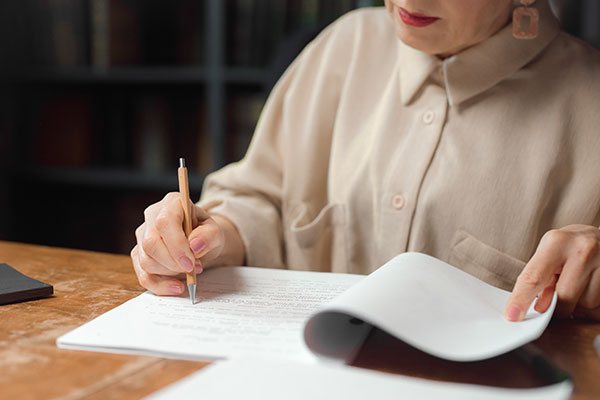 A woman marking a document