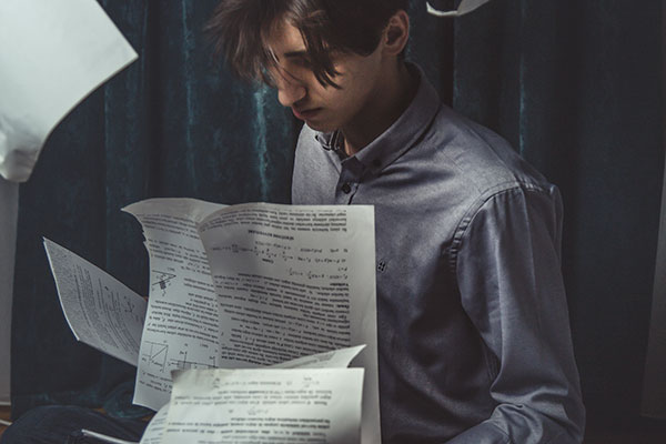 A young man with many papers
