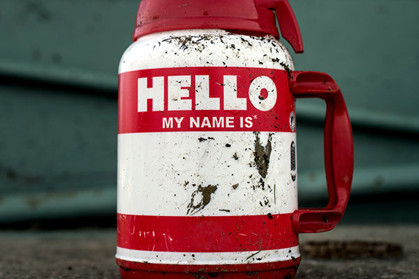 A dirty thermos that says "Hello my name is' on it