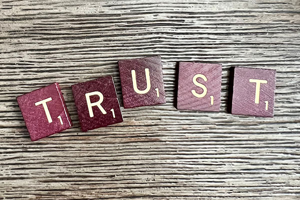Scrabble pieces spelling out the word Trust