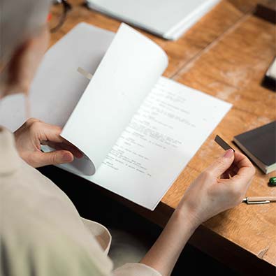 A person looking through a manuscript