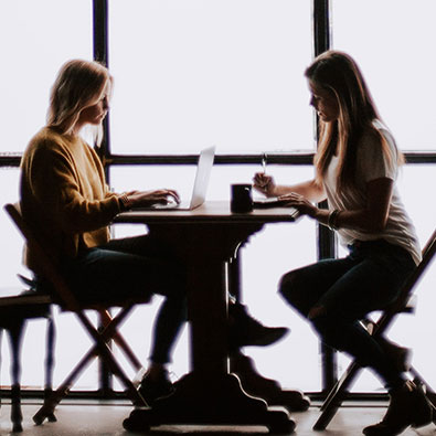 Two women meeting at a table