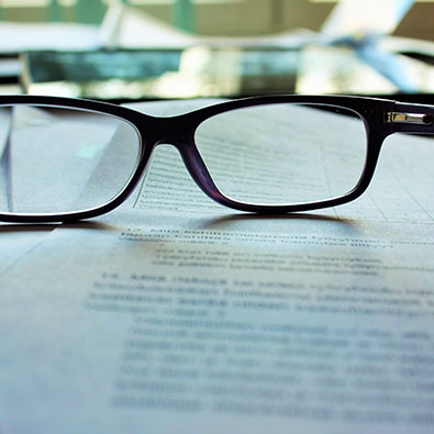 Reading glasses sitting on a document